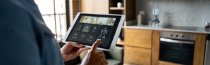 Homeowner controlling the temperature of her smart home using a mobile app
