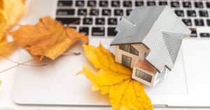 Autumn leaves and house on laptop
