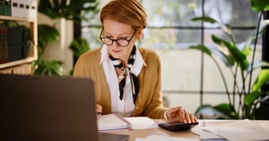 Businesswoman calculating finances