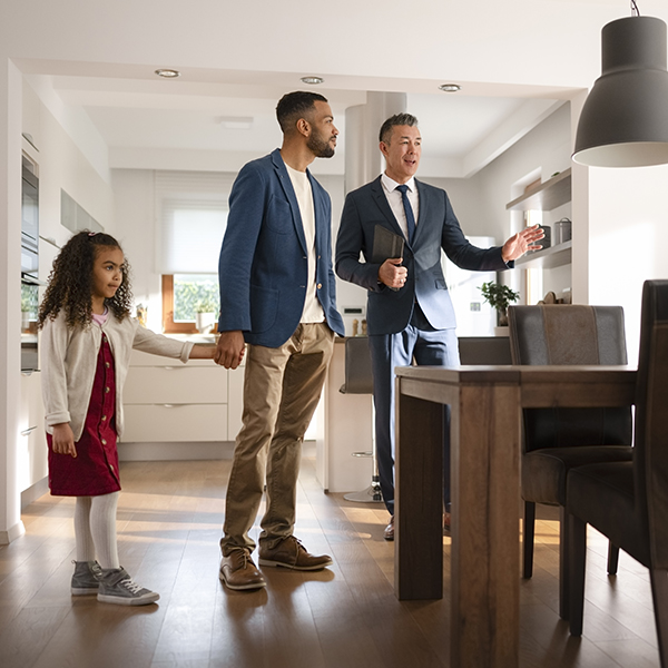 A real estate agent shows a home to a new client. A real estate agent shows a home to a new client.