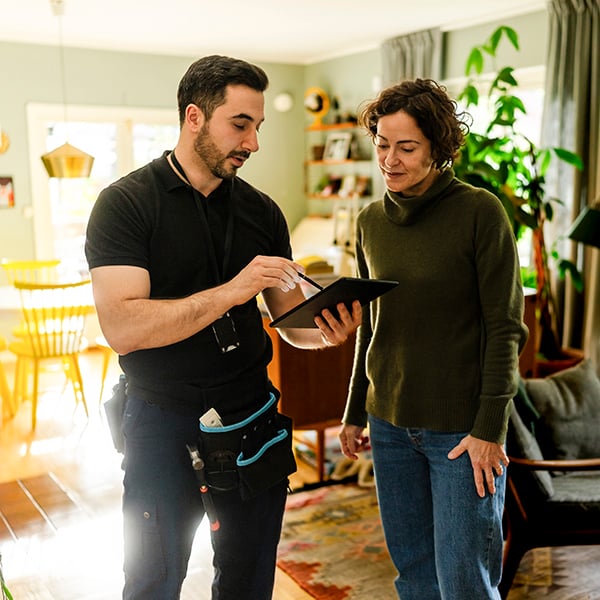 An Old Republic Home Warranty network service provider explains repairs to a homeowner. An Old Republic Home Warranty network service provider explains repairs to a homeowner.