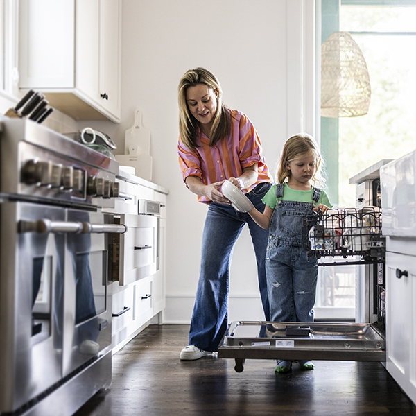 A family using their kitchen appliances A family using their kitchen appliances