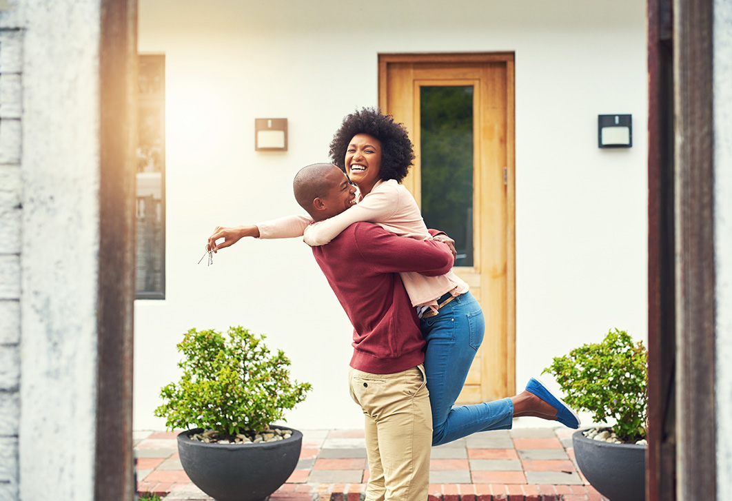 A happy couple dancing after buying their new home. A happy couple dancing after buying their new home.